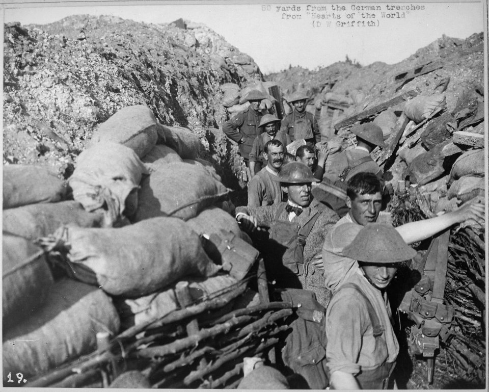 Repairing front line trench after bomb explosion fifty yards from enemy trenches. D. W. Griffith in civilian clothing. D - NARA - 533726