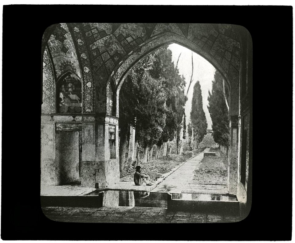 Reproduction of print showing Garden at Fin-Nahē, Kashan, Iran. Man seated under arch LCCN2008675560