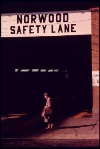 Resident of the Neighborhood in Norwood, Ohio, Walks in Front of the Safety Lane at the Auto Emission Inspection Station...09-1975 (4266522136)