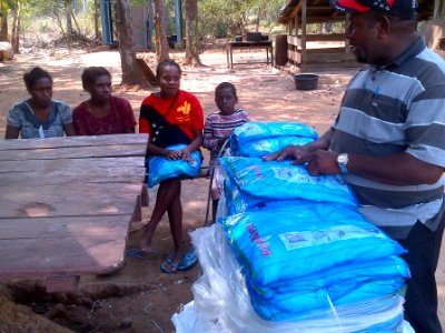 Residents of village discuss use of malaria nets and malaria prevention tips. (15549132322)