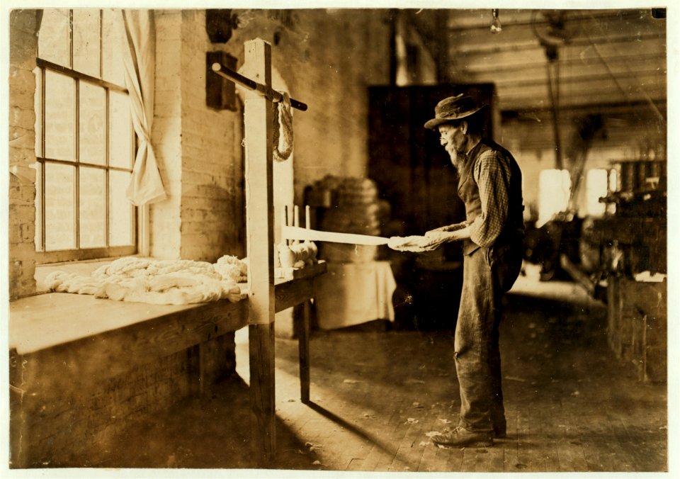 Rhodes Mfg. Company, Lincolnton, N.C. Old man inspecting yarn. Been in cotton mills over 20 years. LOC nclc.01399