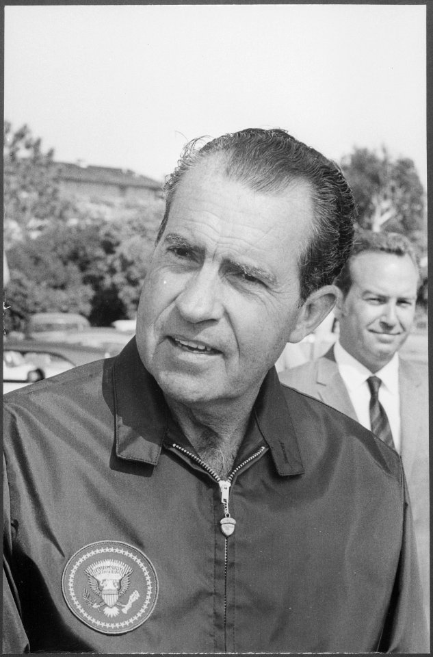 Richard M. Nixon in a windbreaker with the presidential seal. - NARA - 194654