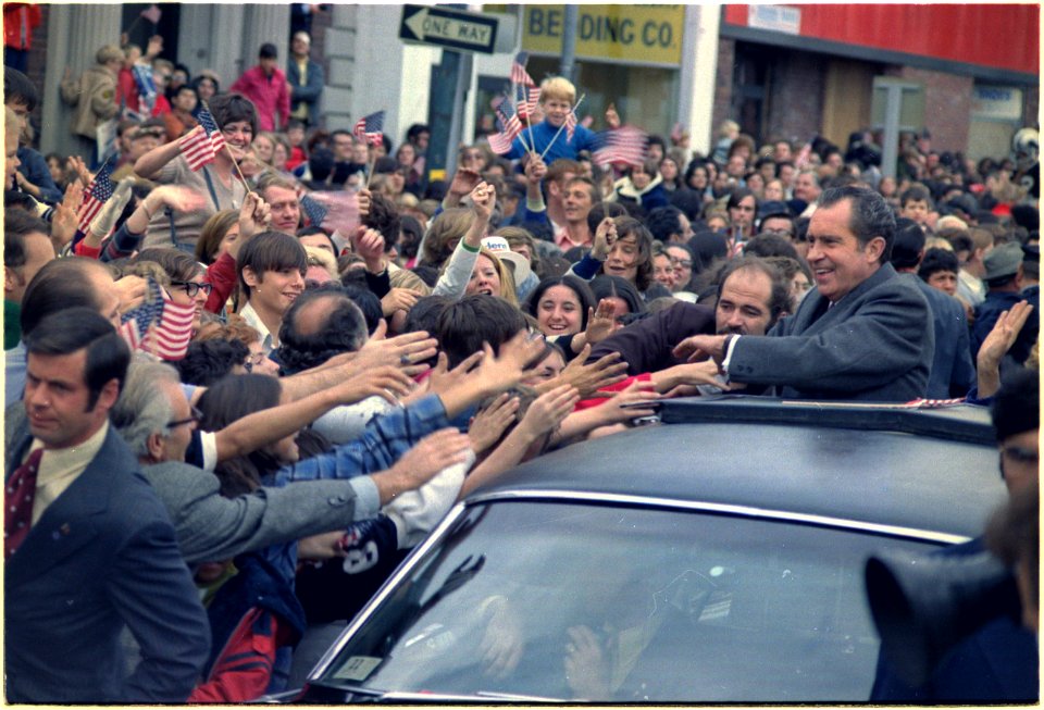 Richard M. Nixon's motorcade being swarmed by people during a campaign event. - NARA - 194458