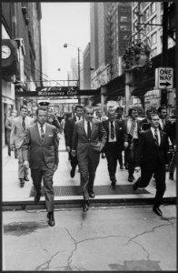 Richard M. Nixon and entourage walking down a street - NARA - 194686 photo