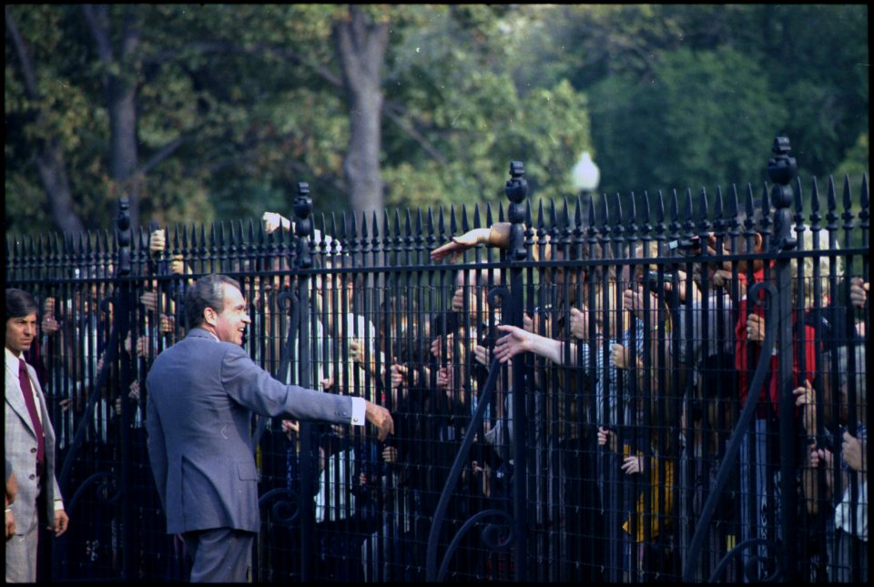 Richard M. Nixon speaking to crowds through the fence outside the White House. - NARA - 194546
