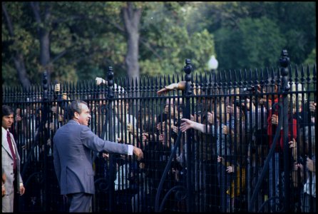 Richard M. Nixon speaking to crowds through the fence outside the White House. - NARA - 194546 photo