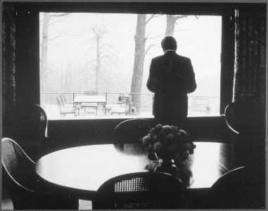 Richard M. Nixon standing in front of a window inside the Camp David lodge. - NARA - 194468 photo