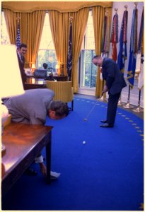 Richard M. Nixon and Bob Hope in the oval office. Bob Hope is putting into an ashtray held by the President. - NARA - 194433