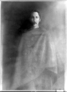 Robert Louis Stevenson, three-quarter length portrait, facing front, draped with cloth LCCN89706398