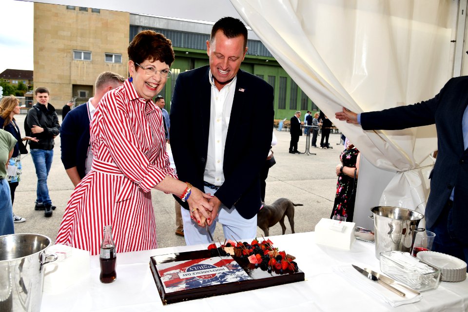 Robin Quinville and Richard Grenell cut the 4th of July Cake, 2019