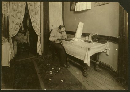 Rolling cigarette cases in tenement home. (For complete details see Miss E.C. Watson's report.) LOC nclc.04271