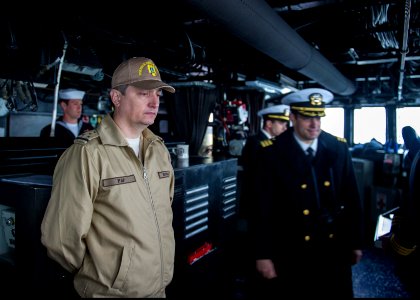 Romanian Navy Warrant Officer Daniel Pap, left foreground, observes operations on the bridge aboard the guided missile destroyer USS Truxtun (DDG 103) in Constanța, Romania, March 8, 2014 140308-N-EI510-051