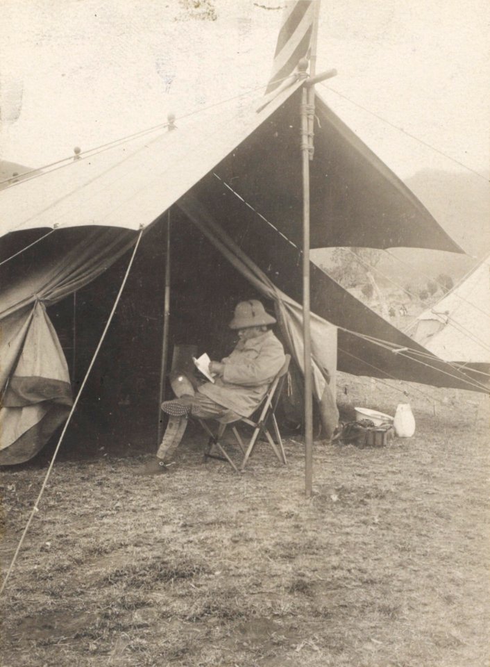 Roosevelt reading in front of his tent in hunting camp LCCN2010645482 (cropped)