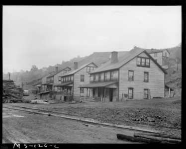 Row of houses in company housing project. This area was flooded about June 1, 1946, when storm sewer (left center in... - NARA - 540290