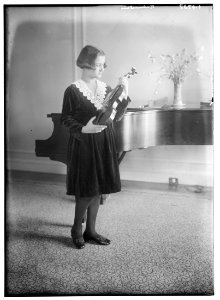 Rubinstein (holding violin, looking at it, near piano) LCCN2014713938