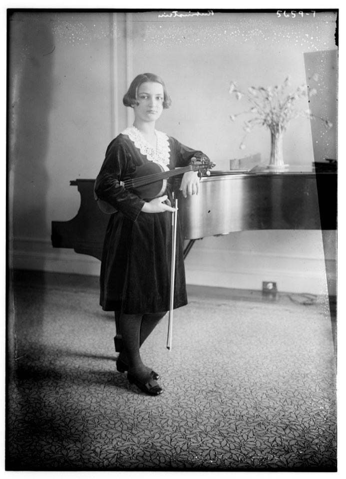Rubinstein (holding violin, looking at it, near piano) LCCN2014713943