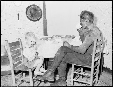 Rufus Sergent, miner, and his son have a bit to eat after work. P V & K Coal Company, Clover Gap Mine, Lejunior... - NARA - 541381