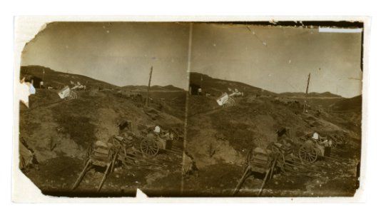 Russian supply carts at the base of a hill; on the hill, a Red Cross field post with wagons for transporting the wounded LCCN2005678332