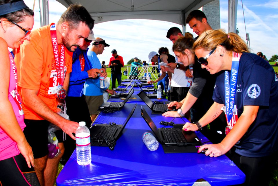 Runners check their times after Half-Marathon 140914-N-CG900-060