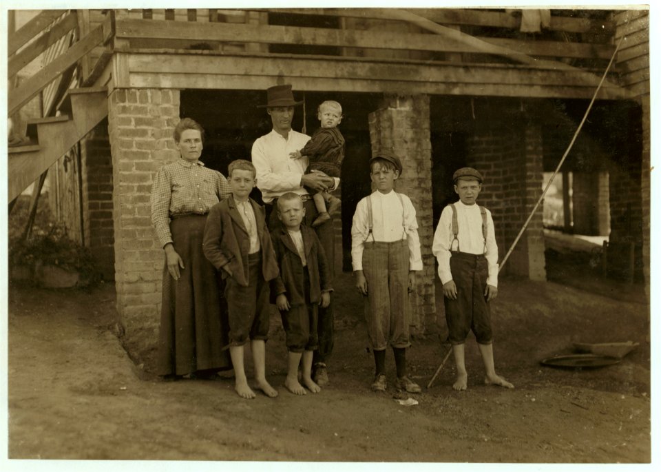 S.D. Ison and family. Father works some. Both boys on right of photo have been in Washington Cotton Mills, Fries, Va., for four years. When I asked the smallest worker how old he was, he LOC cph.3a29778