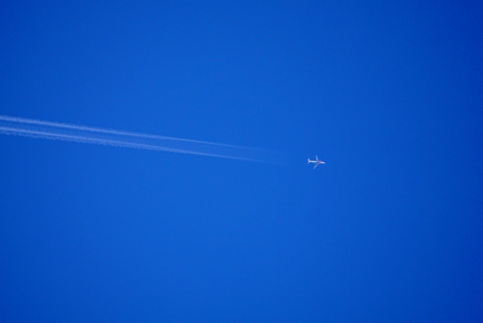 Blue aircraft contrail photo