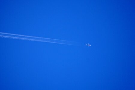 Blue aircraft contrail