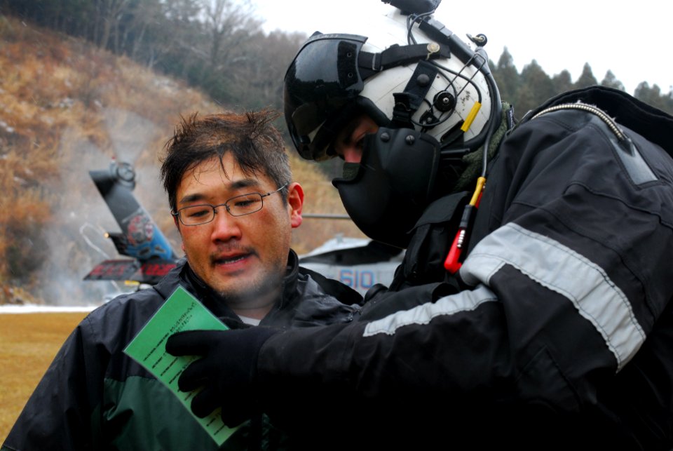 Sailor and California native use translation card to ask Japanese citizen question
