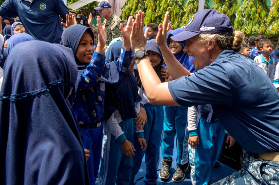 Sailor greets students during a community relations cultural exchange. (41209898572)
