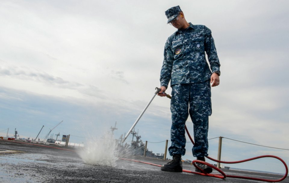 Sailor hoses down flight deck 130401-N-PW661-001