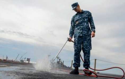 Sailor hoses down flight deck 130401-N-PW661-001