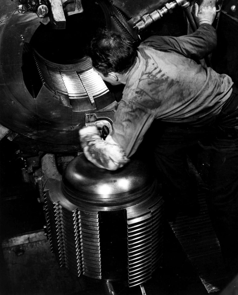 Sailor looking into the breech of 16 inch gun aboard USS Alabama (BB-60)