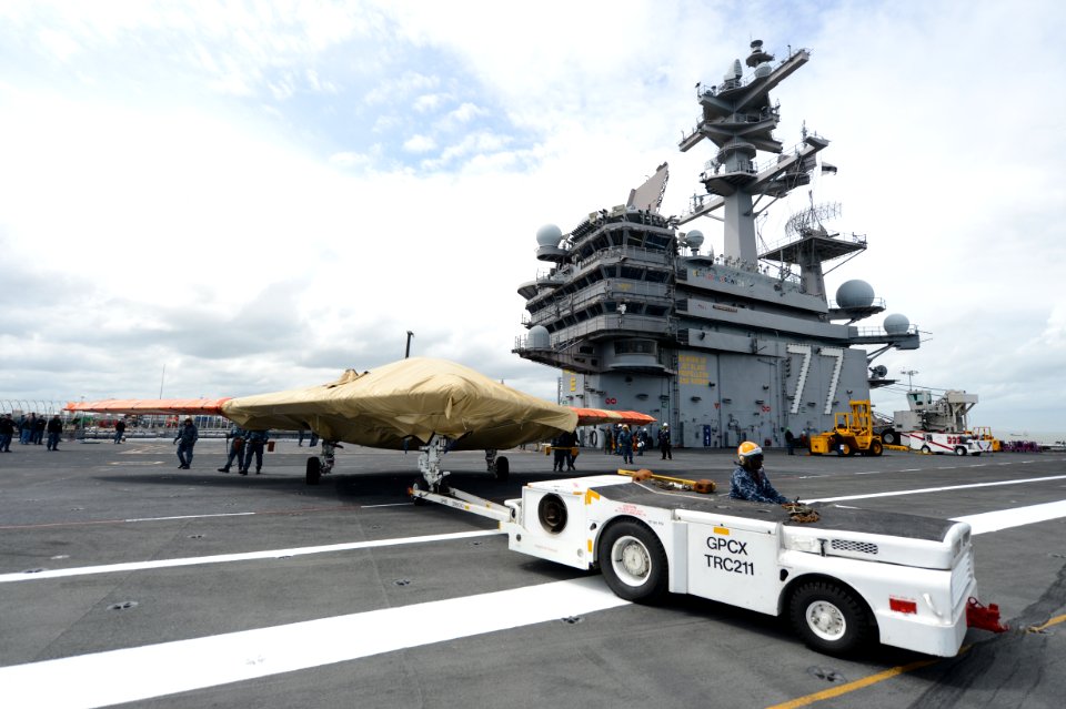 Sailor moves an X-47B aboard USS George H.W. Bush. (8720067325)