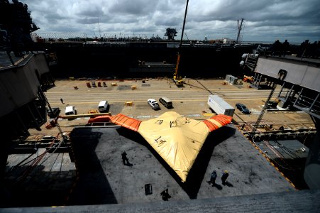 Sailor moves an X-47B is lowered in aircraft elevator aboard USS George H.W. Bush. (8720070303)
