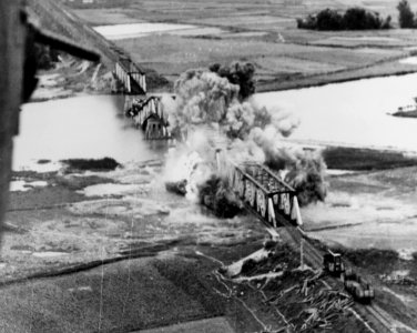 Saigon-Da Nang railroad bridge being bombed in June 1945