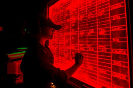 Sailor updates navigational information on the bridge aboard USS Bonhomme Richard. (29314400965)