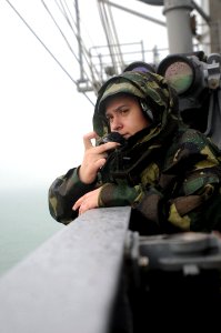 Sailor watches carrier pull into port DVIDS183974