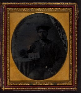 Sailor with cigar in hand holding a double case image of confederate soldiers LCCN2002719391