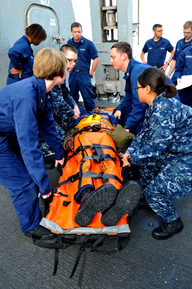 Sailors carry a simulated patient. (8408580406)