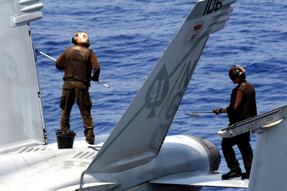 Sailors clean an F-A-18F at sea. (8595820830)