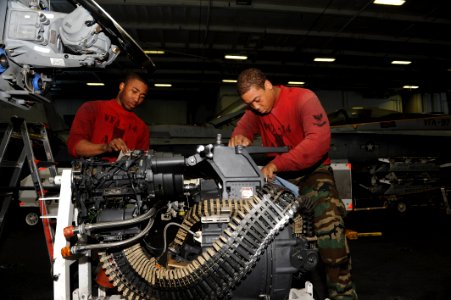 Sailors clean the gatling gun from an F-A-18E. (8407485429)