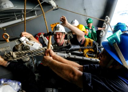 Sailors aboard the USS Theodore Roosevelt secure a fuel probe from INS Shakti during a replenishment-at-sea exercise photo