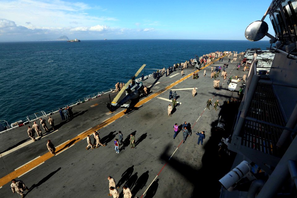 Sailors and Marines gather on the flight deck of USS Kearsarge. (8596676403)