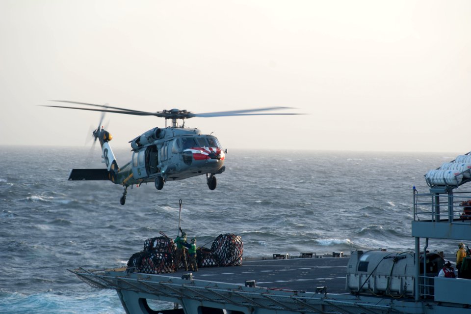Sailors attach supplies to an MH-60S. (8283345471)
