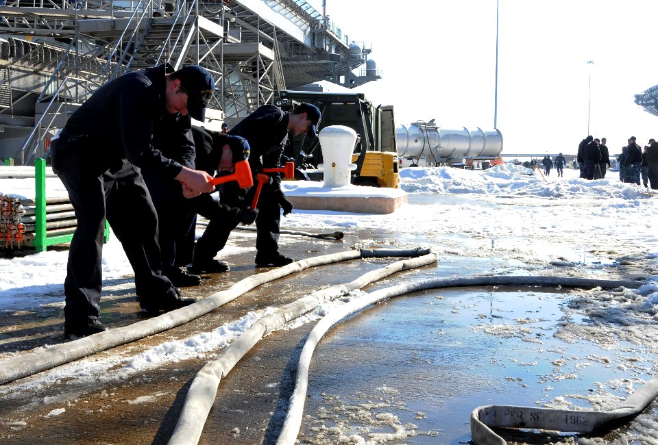 Sailors break ice on the deck of USS George H.W. Bush. (16469122860)