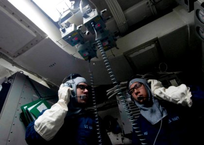 Sailors check communications during a drill. (8227415086)