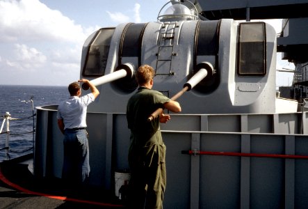 Sailors clean gun barrels aboard USS Pyro (AE-24), 1 November 1986 (6421830)