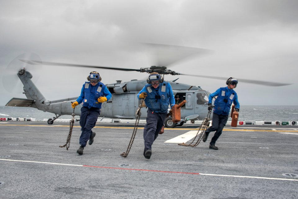 Sailors conduct a chock and chain evolution with an SH-60 Sea Hawk aboard USS Wasp. (21856860402)