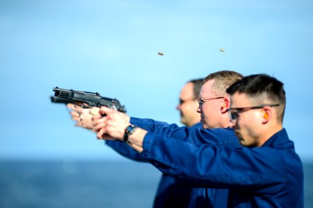 Sailors fire M9 pistols. (8653258306) photo