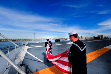 Sailors fold the American flag aboard USS Carl Vinson. (8448063310)