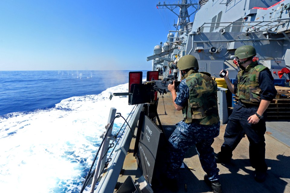 Sailors fire a .50-caliber machine gun. (15156605277)